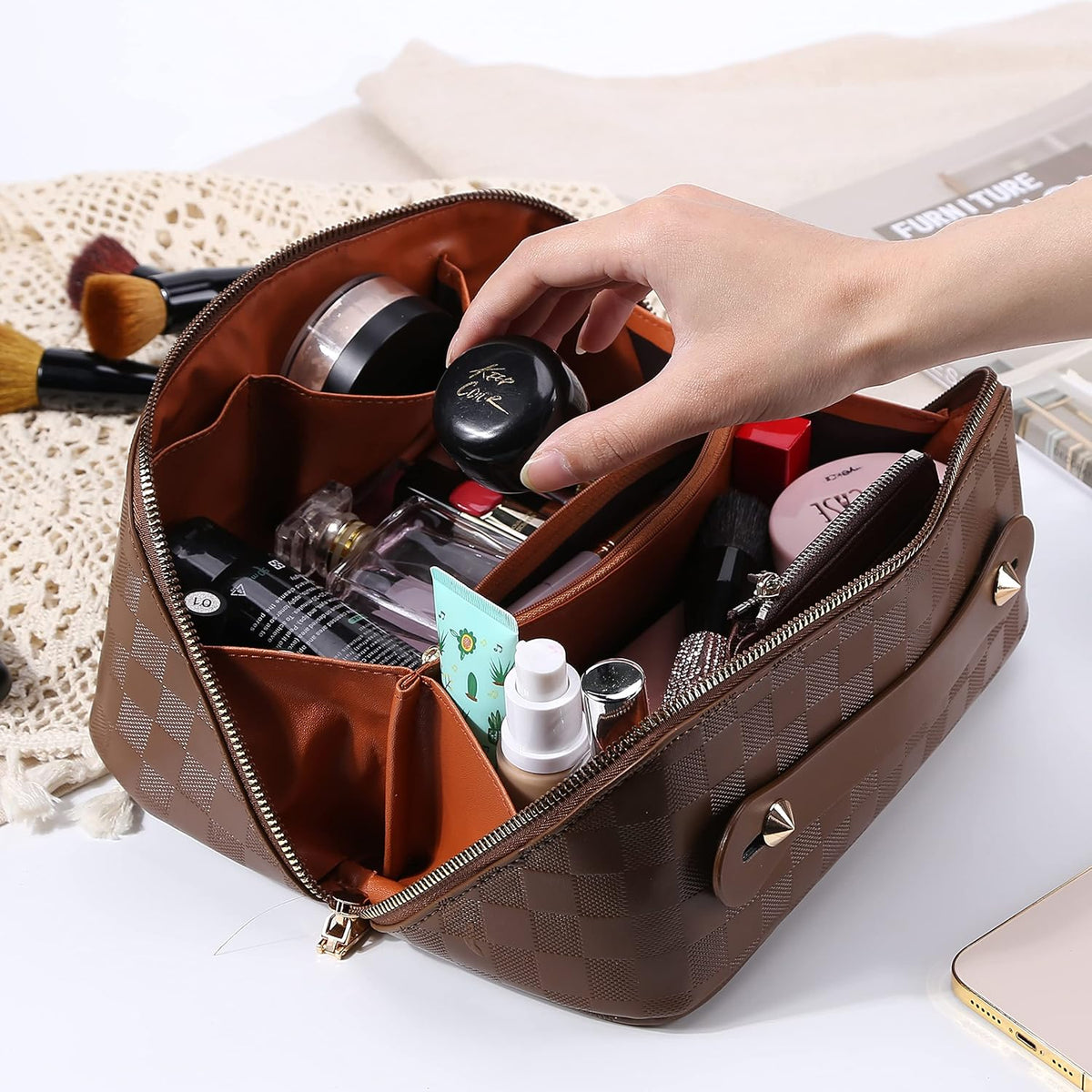 Open brown checked travel makeup bag with small bottles standing upright