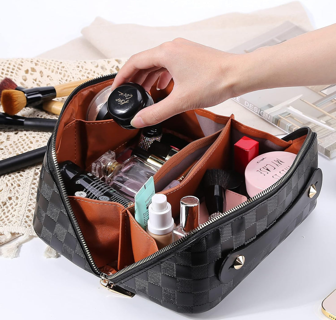 Open black checked travel makeup bag with makeup and skincare standing in its compartments